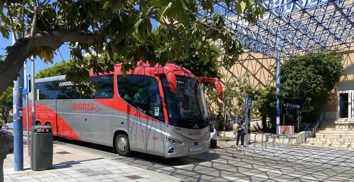 Red and grey Avanza express bus parked at Marbella bus station