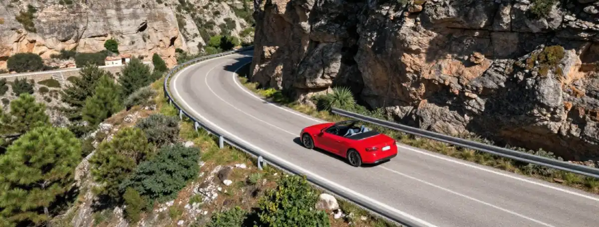 Convertible car driving on the Ronda road from Marbella through the mountains