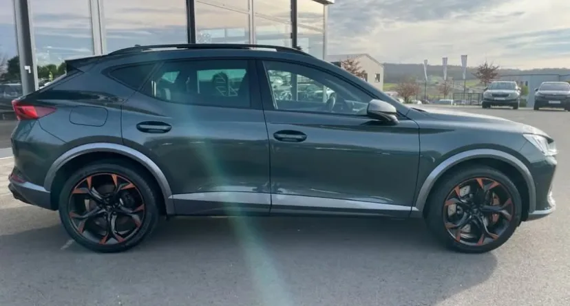 A grey Cupra Formentor parked outdoors in Marbella, showcasing its sporty SUV design, sculpted body lines, black alloy wheels with copper accents, and modern premium styling. The powerful and stylish appearance makes it an ideal choice for travellers looking to rent a Cupra Formentor in Marbella, offering performance, comfort, and a luxurious driving experience along the Costa del Sol. The bright setting highlights the vehicle's dynamic look and reinforces its appeal for anyone searching to rent a car in Marbella.