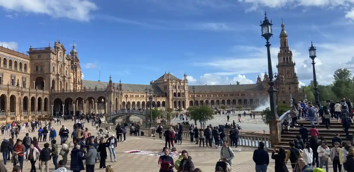 Plaza de España in Seville with grand architecture, fountain and tourists